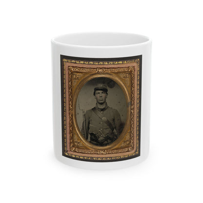 Antique tintype of a young soldier in a kepi with a rifle and bayonet, set in an ornate gold oval frame.