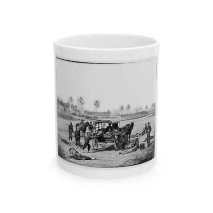Black and white 1860s view of wounded men on sand beside an ambulance wagon, with an officer and drum nearby.