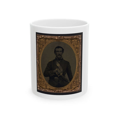 Sepia tintype of a moustached soldier in a dark uniform with a sash, holding a sabre, in an embossed gilt oval frame.