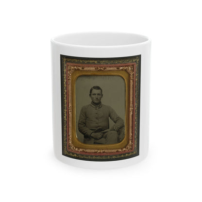 Sepia tintype portrait of a seated soldier in a buttoned grey coat, set in a gilt case lined with red velvet.