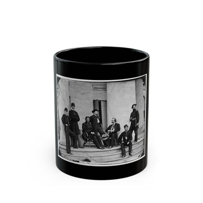 Black and white 1860s view of seven uniformed men posed on stone steps in front of tall columns.