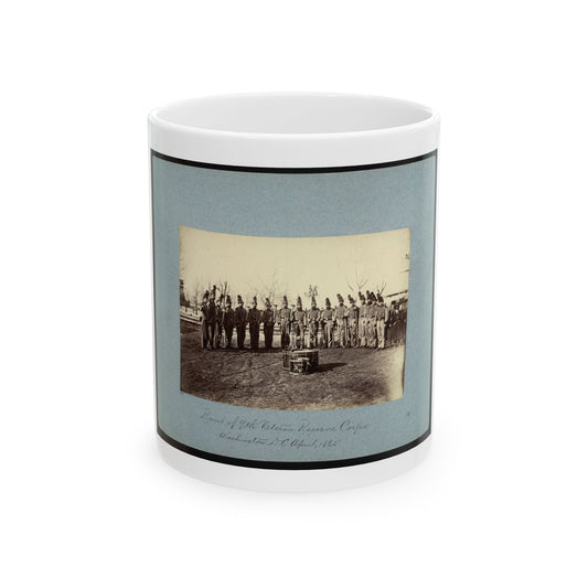 Sepia 1865 view of a uniformed band in plumed caps and striped jackets standing in a row before a bass drum.