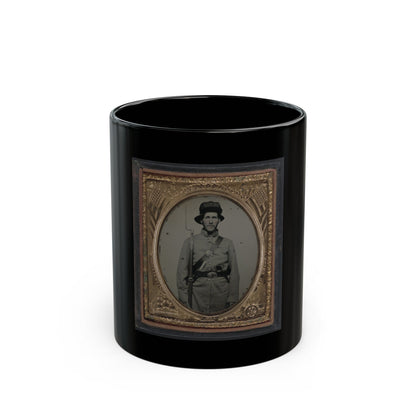 Monochrome tintype of a Civil War soldier with a rifle and bayonet, in a gilt frame embossed with flags and stars.