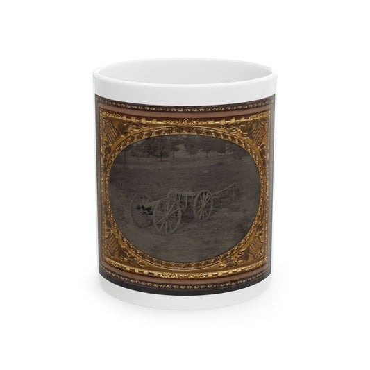 Monochrome tintype of a cannon and limber on open grass, in an oval vignette within a gilt embossed case.