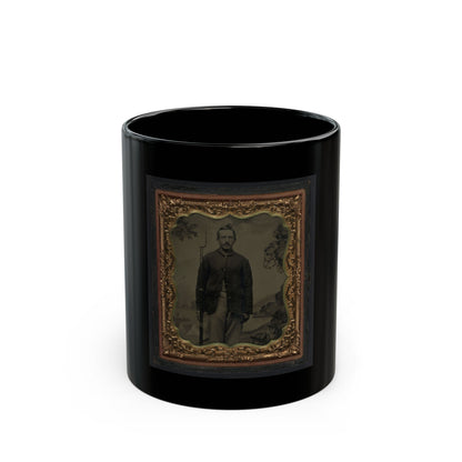Antique tintype of a standing man holding a rifle before a painted landscape backdrop, in an ornate gilt case.