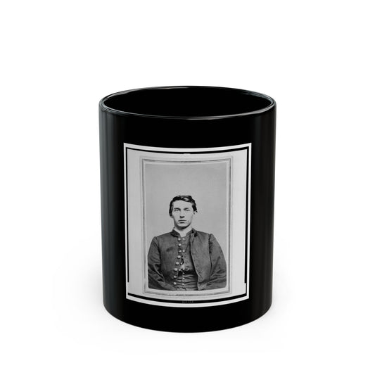 Black and white vintage portrait of a young man in a buttoned dark jacket, framed by a thin double border.