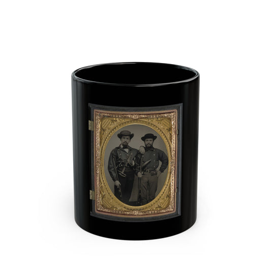 Oval tintype of two bearded men in dark jackets and wide-brimmed hats, one holding a rifle, in a gilt case.