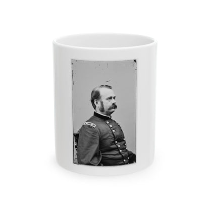 Black and white 19th-century profile portrait of a mustached man in a dark military uniform, seated in a wooden chair.