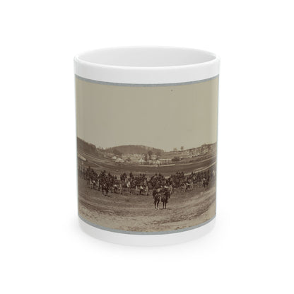 Sepia print of mounted soldiers and artillery cannons on an open field, with a distant camp beyond.
