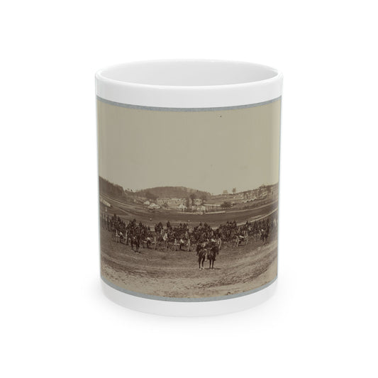 Sepia print of mounted soldiers and artillery cannons on an open field, with a distant camp beyond.