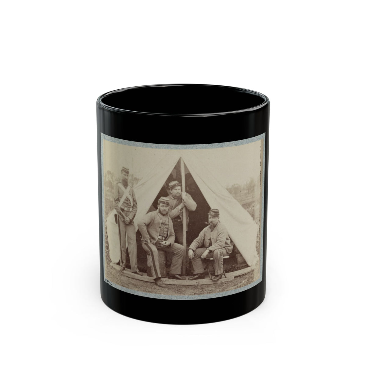Sepia print of four soldiers in forage caps grouped before a white canvas tent on a wooden platform.