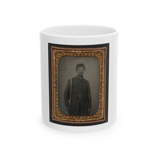 Antique tintype of a bearded soldier in a dark uniform and forage cap holding a rifle, in a gilt-embossed case.