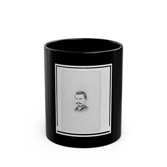 Black and white vintage portrait of a man with a moustache and goatee, with faint handwriting below.