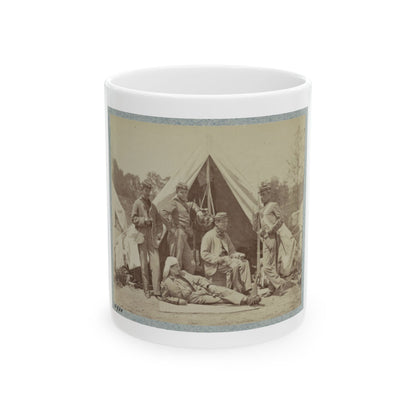 Sepia print of five soldiers posed before a white canvas tent, one reclining in front and one holding a rifle.