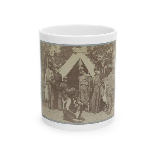 Sepia print showing several soldiers with rifles beside a peaked canvas tent, with one figure kneeling in front.