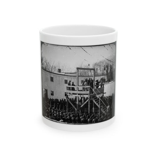 Black and white 1860s scene of a wooden gallows platform with figures, ringed by rows of armed soldiers and a crowd.