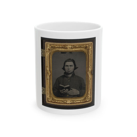 Antique tintype of a man holding a small open book, in an ornate gilt case with a velvet mat.