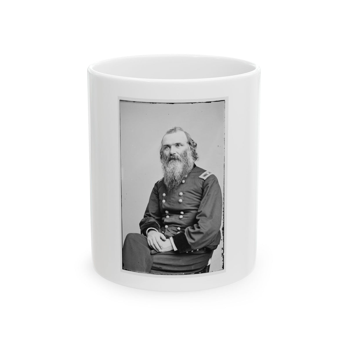 Black and white 19th-century studio portrait of a seated bearded man in a dark military uniform with hands clasped.