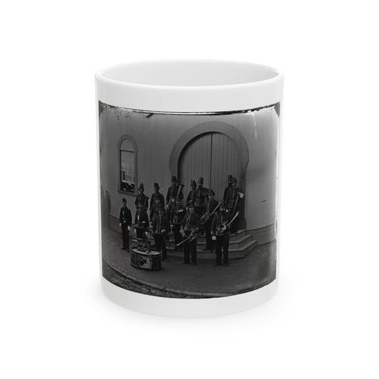 Black and white mid-19th-century view of a military band in dark uniforms with brass horns and bass drums.