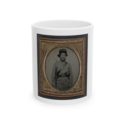 Monochrome tintype of a Civil War soldier with a rifle and bayonet, in a gilt frame embossed with flags and stars.