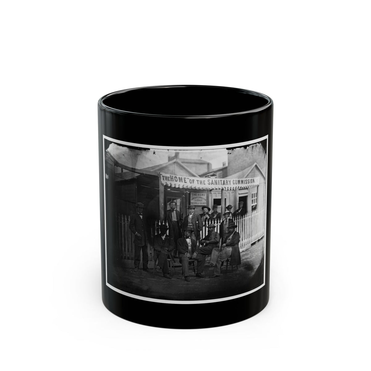 Black and white 19th-century view of men in hats outside a wooden lodge with a Sanitary Commission banner.
