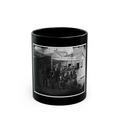 Black and white 19th-century view of men in hats outside a wooden lodge with a Sanitary Commission banner.