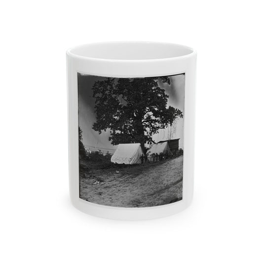 Black and white print of a large oak shading two white canvas tents, with soldiers standing nearby.