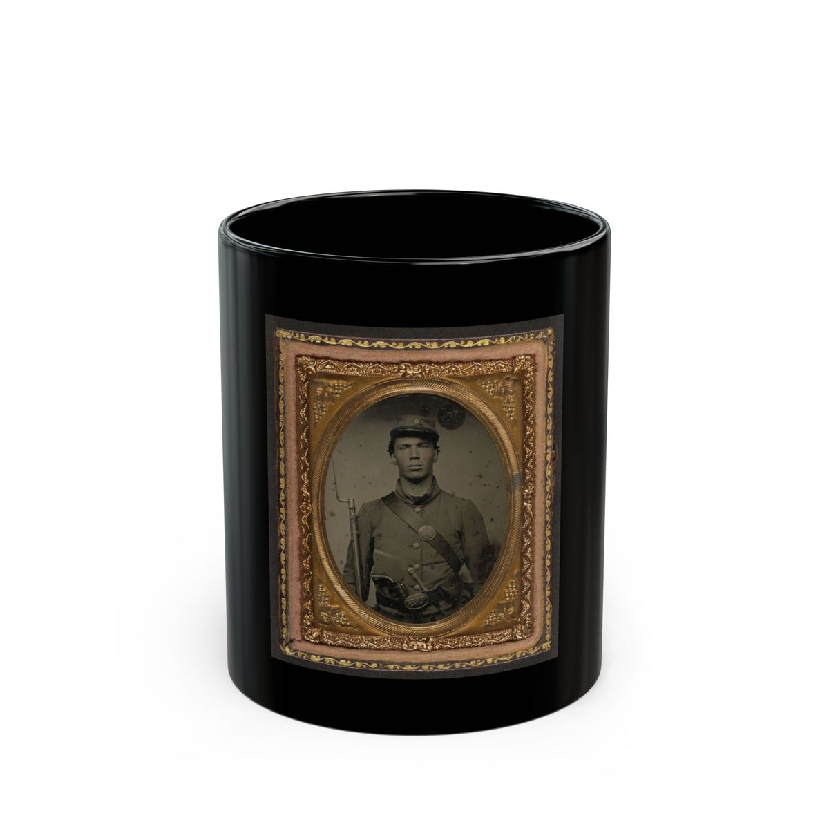 Antique tintype of a young soldier in a kepi with a rifle and bayonet, set in an ornate gold oval frame.