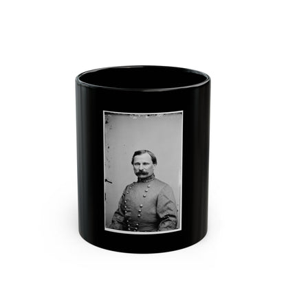 Black and white 1860s studio portrait of a mustached man in a double-breasted coat with an embroidered collar.