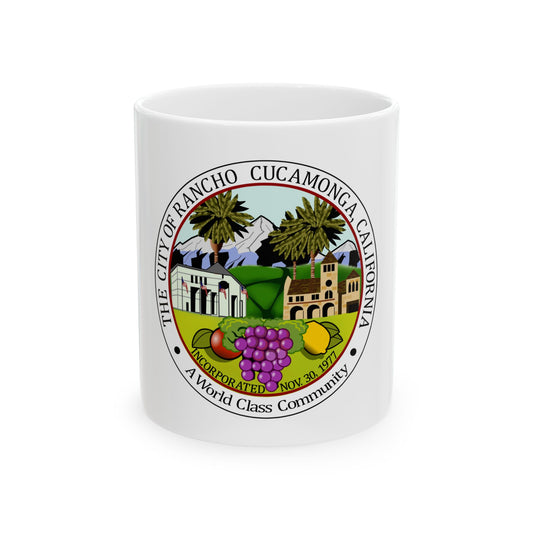 Circular seal of Rancho Cucamonga, California, with palm trees, mountains and a church above grapes and fruit.