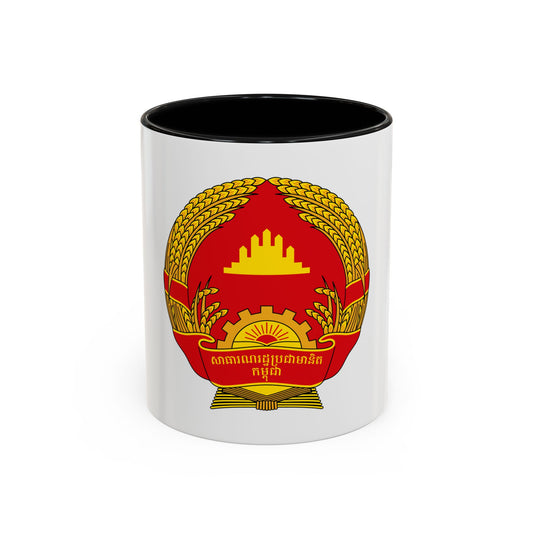 Red and gold national emblem with a wheat wreath, cogwheel, rising sun and a temple silhouette above.