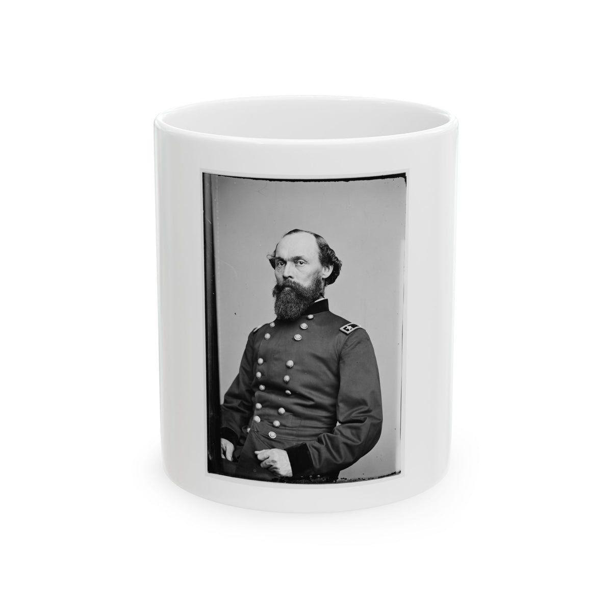 Black and white vintage portrait of a bearded officer in a double-breasted uniform, one hand resting on his hip.