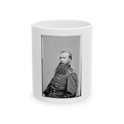 Black and white 19th-century studio portrait of a bearded man in a dark military uniform, seated.