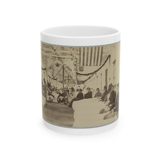 Sepia view of a decorated Civil War hospital ward with rows of patients, attendants and a striped flag overhead.