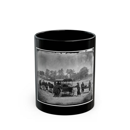 Black-and-white 1860s scene of stretcher bearers and an ambulance wagon carrying wounded men across a sandy field.