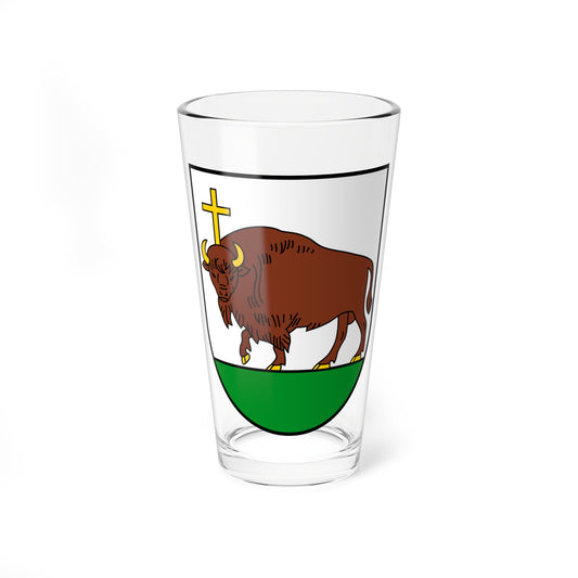 Brown bison walking in profile under a gold cross on a white heraldic shield, standing on a green base.