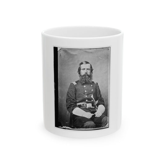 Black and white studio portrait of a bearded officer in a double-breasted uniform, seated with a sword at his waist.