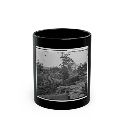Black and white 1860s view of a sandbag parapet and sharpened timber barricades on a wooded hillside.