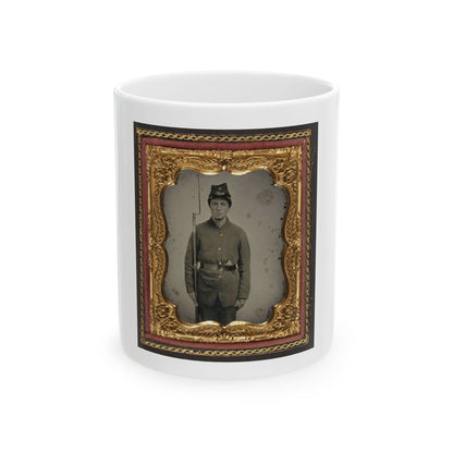 Antique tintype of a standing young soldier in a kepi holding a rifle with bayonet, in an ornate gold floral frame.