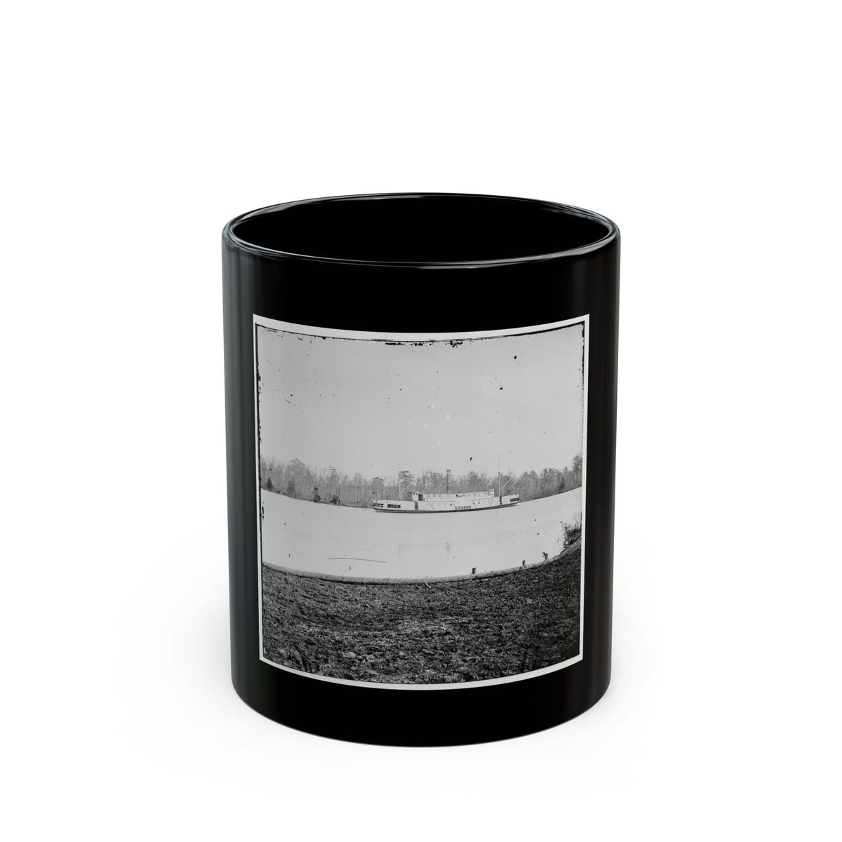 Black and white historical view of a steamboat on a calm river, with leafless trees on the far bank.