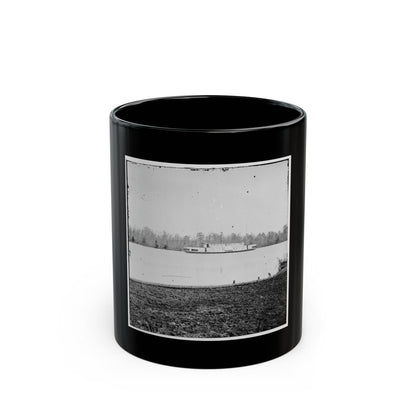 Black and white historical view of a steamboat on a calm river, with leafless trees on the far bank.