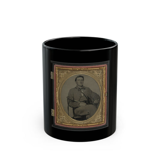 Antique tintype portrait of a seated young man in a military-style jacket holding a sabre, in an ornate gold frame.