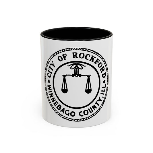 Black and white circular seal of Rockford, Illinois, showing scales of justice under a finial within a rope border.