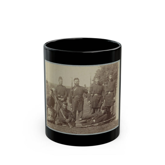 Sepia print showing 19th-century infantrymen with muskets and a snare drum posed outdoors on grass.
