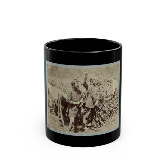 Sepia-toned print of two bearded soldiers in forage caps beside a canvas tent with rifles leaning against it.