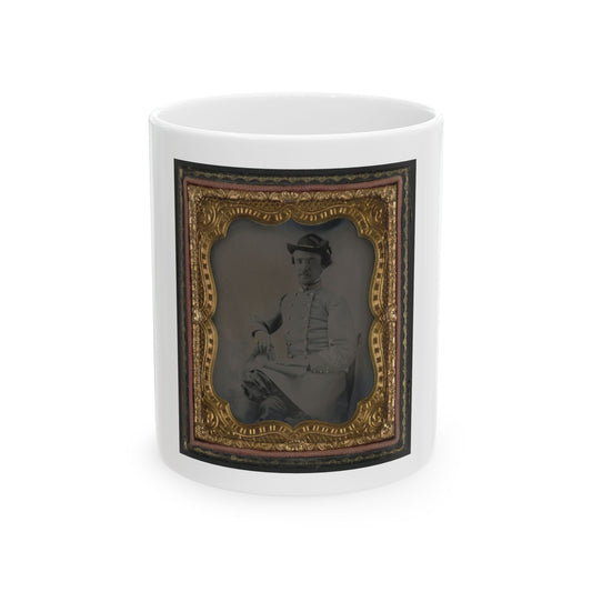 Tintype portrait of a seated man in a light grey military-style jacket and slouch hat, in an embossed gilt case.