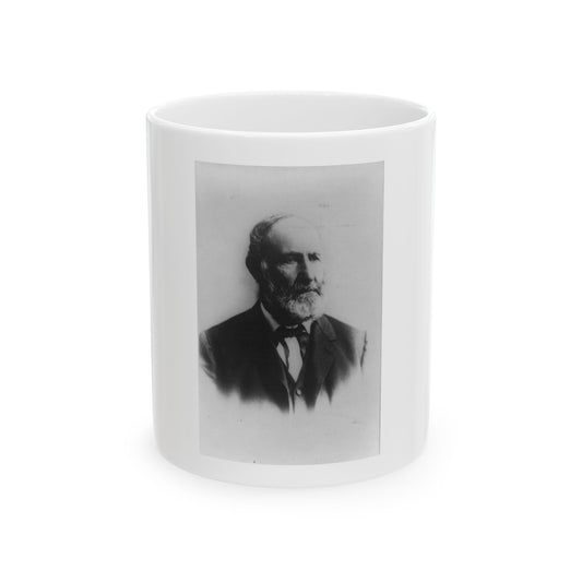 Black and white vignetted portrait of an older bearded man in a dark suit and bow tie against a pale background.