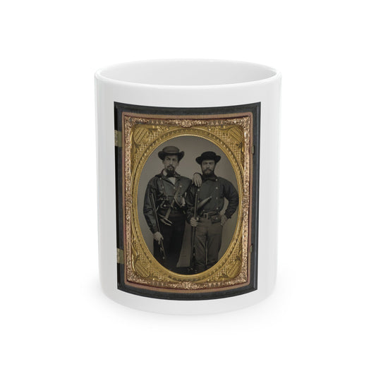 Oval tintype of two bearded men in dark jackets and wide-brimmed hats, one holding a rifle, in a gilt case.