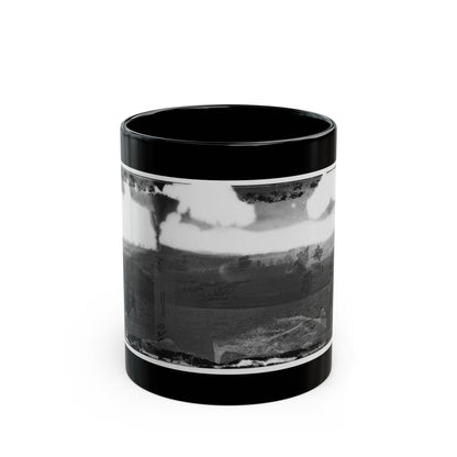 Black and white stereograph of a seated man with binoculars looking over rolling fields and scattered trees.