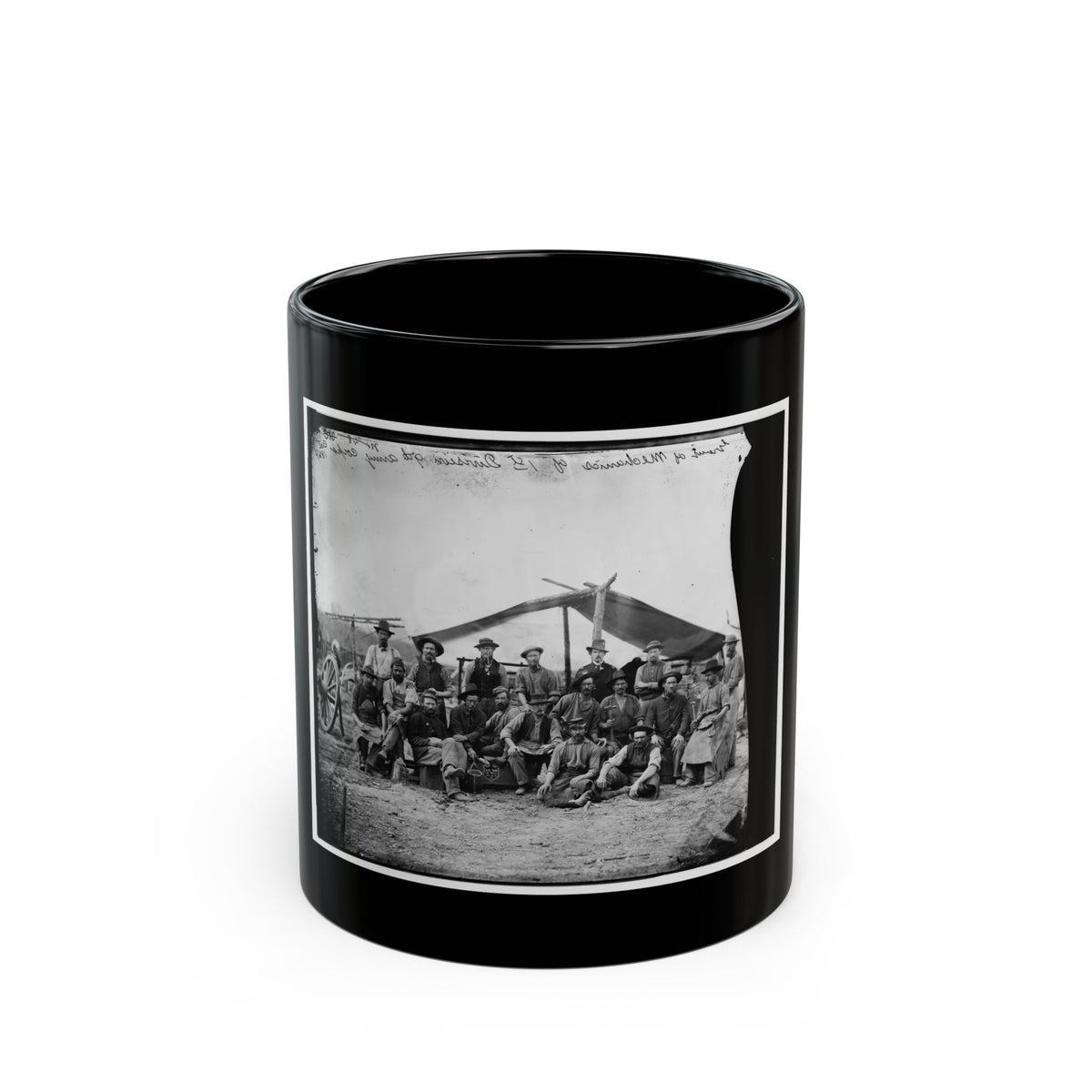 Black-and-white albumen view of about sixteen workmen in aprons and slouch hats posed before a canvas tent.